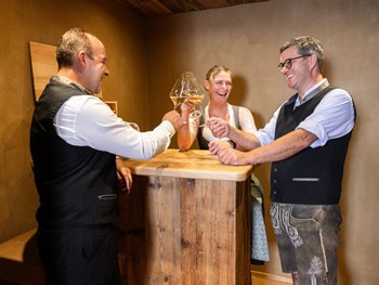 Drei Weinsommeliers stoßen mit Wein an